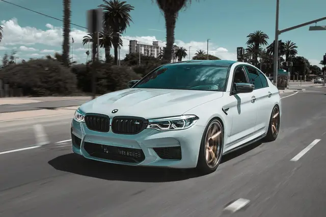 BMW M5 driving through a city