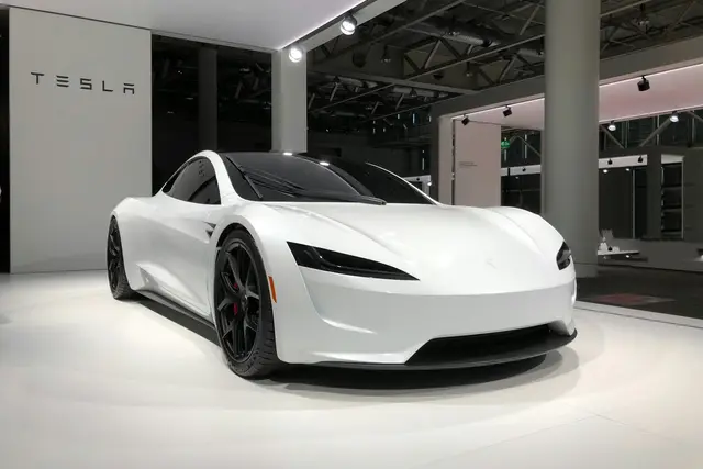 White Tesla Roadster in a showroom